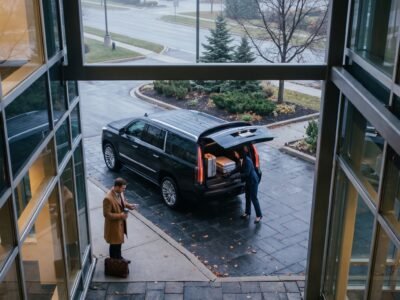 Chauffeur placing luggage into the boot of an executive vehicle showcasing transparent Pickering Pearson limo prices.